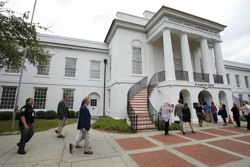 Members of the media and general public gathered outside the Colleton County Courthouse Thursday, March 2, 2023, in Walterboro, S.C. As the double murder trial of Alex Murdaugh wraps, the heaps of public attention poured on the case's many twists and turns. The 54-year-old attorney is standing trial on two counts of murder in the shootings of his wife and son at their Colleton County home and hunting lodge on June 7, 2021. (AP Photo/Chris Carlson)