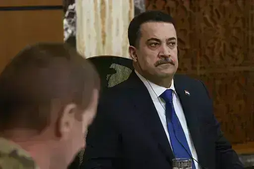 Iraqi Prime Minister Mohammed Shia al-Sudani, right, chairs the first session of negotiations between Iraq and the United States to wind down the International Coalition mission in Baghdad, Iraq, Saturday, Jan. 27, 2024. (AP Photo/Hadi Mizban, Pool)