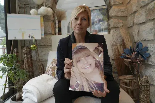 Stephanie Mistre, 51, holds a picture of her daughter, Marie Le Tiec, a teenager who died by suicide in 2021, on Dec. 10, 2024, in Cassis, southern France. (AP Photo/Tom Nouvian)