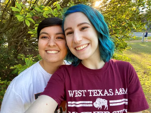 This Aug. 15, 2022, photo shows El Johnson, right, with her girlfriend, Sara Goodie, in Austin, Texas. Johnson has decided not to bear children, though she hasn’t ruled out adoption. The birth rate in the U.S. has dropped dramatically as more young people decide not to have children. (El Johnson via AP)