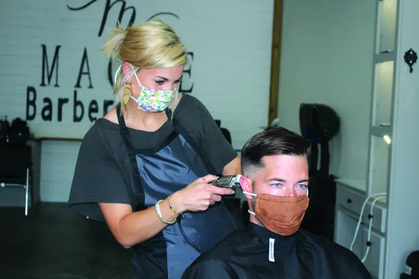 Governor Tate Reeves reopened barbershops, salons, and gyms on Monday May 11, as the economy continues to recover from the COVID-19 pandemic. Barber Sara Hayman of Magee Barber and Style, left, was happy to be back at work.