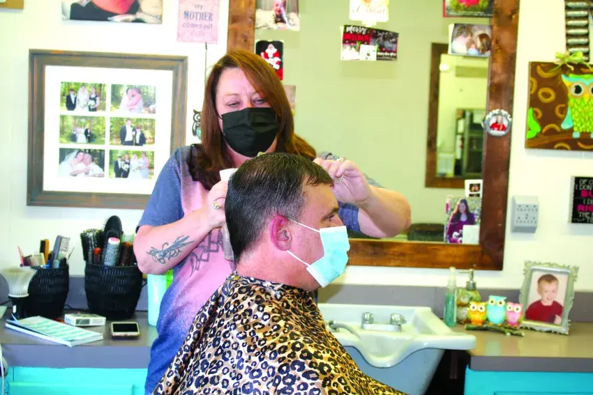 Governor Tate Reeves reopened barbershops, salons, and gyms on Monday, May 11, as the economy continues to recover from the COVID-19 pandemic. Barber Kristi Prince of City Barber Shop, above, said she was happy to be back at work.